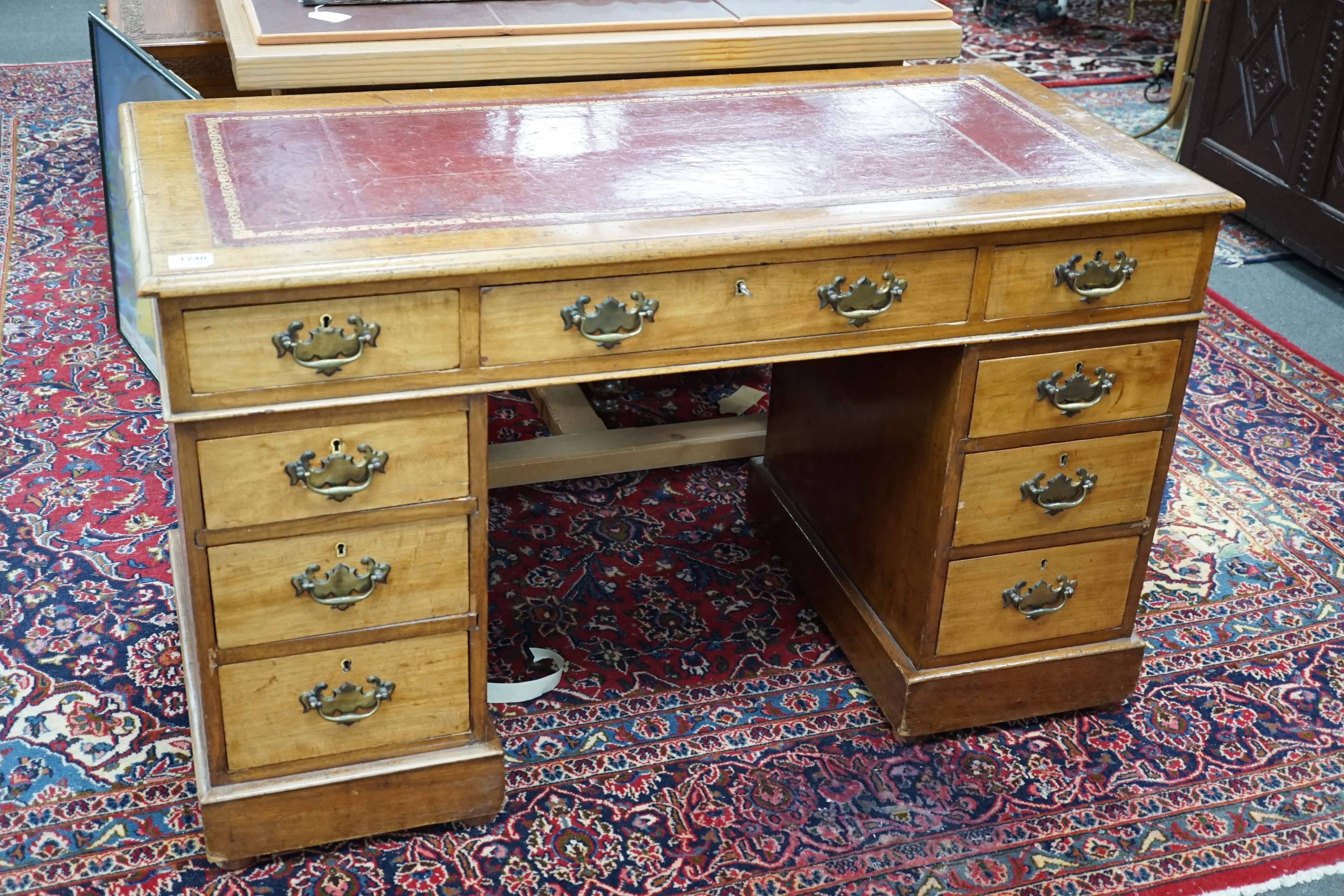 An Edwardian walnut leather-topped pedestal desk, width 120cm, height 72cm